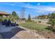 Serene backyard featuring Adirondack chairs, a charming white fence, and lush greenery at 360 Basilwood Way, Highlands Ranch, CO 80126