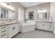 Elegant bathroom with dual vanities, soaking tub, modern fixtures, and hexagonal tile flooring at 360 Basilwood Way, Highlands Ranch, CO 80126
