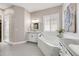 Luxurious bathroom featuring a soaking tub, walk-in shower, dual vanities, and hexagonal tile flooring at 360 Basilwood Way, Highlands Ranch, CO 80126