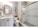 Stylish bathroom featuring a glass enclosed shower, white vanity, elegant mirror, and modern fixtures at 360 Basilwood Way, Highlands Ranch, CO 80126