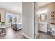 View of bedroom with wood floors and bath with vanity, mirror and toilet with tile floors at 360 Basilwood Way, Highlands Ranch, CO 80126