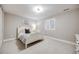 Bright bedroom with a large window, white furniture, and neutral carpet at 360 Basilwood Way, Highlands Ranch, CO 80126