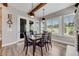 Dining room with wood beams, modern lighting, and views of the outside landscape at 360 Basilwood Way, Highlands Ranch, CO 80126