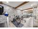Home gym featuring a stone accent wall and a variety of exercise equipment at 360 Basilwood Way, Highlands Ranch, CO 80126