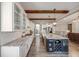 Spacious kitchen with white cabinets, granite counters, wine rack, and island with bar seating at 360 Basilwood Way, Highlands Ranch, CO 80126