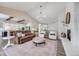 Open-concept living room featuring a stone fireplace, chandelier, and seamless flow into the kitchen at 360 Basilwood Way, Highlands Ranch, CO 80126
