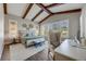 Comfortable main bedroom with beamed ceilings, plantation shutters, and views of the outside at 360 Basilwood Way, Highlands Ranch, CO 80126