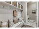 Inviting mudroom with a built-in bench, coat hooks, storage baskets, and easy access to the laundry room at 360 Basilwood Way, Highlands Ranch, CO 80126