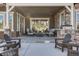 Relax on the covered patio with outdoor seating, a fire pit, and stone accents at 360 Basilwood Way, Highlands Ranch, CO 80126