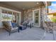 This spacious covered patio features a built-in grill and cozy seating around a fire pit at 360 Basilwood Way, Highlands Ranch, CO 80126