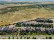 Stunning aerial view of a well-planned community nestled against rolling hills, highlighting the scenic surroundings at 9395 Night Star Pl, Lone Tree, CO 80124