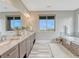 Large primary bath features dual sinks, quartz counters, soaking tub and stylish fixtures at 9395 Night Star Pl, Lone Tree, CO 80124