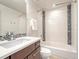 Modern bathroom with white subway tiles, mosaic accents, updated sink, and a bathtub with shower at 9395 Night Star Pl, Lone Tree, CO 80124