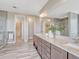 Spacious primary bath showcases dual vanity, walk-in closet, and luxurious finishes at 9395 Night Star Pl, Lone Tree, CO 80124