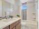 Bathroom features a shower-tub combo, neutral accents, and modern vanity at 9395 Night Star Pl, Lone Tree, CO 80124
