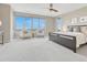 Spacious bedroom boasts a large window with city views, carpet, and stylish decor at 9395 Night Star Pl, Lone Tree, CO 80124
