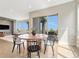 Bright dining area with modern furniture, adjacent to the living room and an outdoor patio at 9395 Night Star Pl, Lone Tree, CO 80124