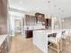 Elegant kitchen with a large center island, dark wood cabinets, and stylish pendant lighting at 9395 Night Star Pl, Lone Tree, CO 80124