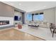 Bright living room features a modern fireplace, large windows with scenic views, and stylish furniture at 9395 Night Star Pl, Lone Tree, CO 80124