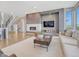 Cozy living room with a modern fireplace, neutral decor, and ample natural light at 9395 Night Star Pl, Lone Tree, CO 80124