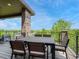 Outdoor dining area on a deck, featuring a table and chairs with scenic views of the surrounding landscape at 9395 Night Star Pl, Lone Tree, CO 80124