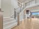 Elegant staircase with modern railings, leading to a bright, open-concept living space at 9395 Night Star Pl, Lone Tree, CO 80124