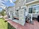 The backyard features a deck with stone columns, brick trim and steps down to the yard at 17955 E 107Th Pl, Commerce City, CO 80022