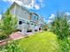 A backyard showcasing a deck, green lawn, and tasteful landscaping, creating a serene outdoor space at 17955 E 107Th Pl, Commerce City, CO 80022