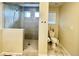 Stylish bathroom featuring a glass-enclosed shower and a separate toilet area with modern fixtures at 17955 E 107Th Pl, Commerce City, CO 80022