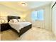 Cozy bedroom with a dark wood bed frame, neutral bedding, and soft, natural lighting at 17955 E 107Th Pl, Commerce City, CO 80022