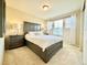Comfortable bedroom with a stylish bed frame, matching bedside tables, and bright, natural lighting at 17955 E 107Th Pl, Commerce City, CO 80022