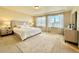 Comfortable bedroom with large windows and a stylish area rug beneath the bed at 17955 E 107Th Pl, Commerce City, CO 80022