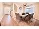 Dining room features a modern chandelier, hardwood floors, large window and access to staircase at 17955 E 107Th Pl, Commerce City, CO 80022