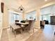 Dining room with modern lighting, a large window, and upholstered furniture at 17955 E 107Th Pl, Commerce City, CO 80022