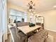 Dining room features a modern chandelier, large mirror and unique upholstered chairs and bench at 17955 E 107Th Pl, Commerce City, CO 80022