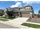 Charming two-story home featuring a well-kept lawn and a spacious driveway leading to a two-car garage at 17955 E 107Th Pl, Commerce City, CO 80022