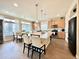Bright kitchen featuring a large island, white countertops, stainless steel appliances, and natural wood cabinets at 17955 E 107Th Pl, Commerce City, CO 80022