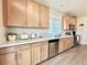 Bright kitchen boasts stainless appliances, ample cabinets, a double sink and light countertops at 17955 E 107Th Pl, Commerce City, CO 80022