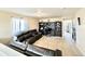 Open concept room with wall-to-wall carpet, a dark leather couch, and a large desk with built-ins at 17955 E 107Th Pl, Commerce City, CO 80022