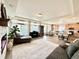 Open-concept living space with hardwood floors, large windows, and a view of the kitchen and dining area at 17955 E 107Th Pl, Commerce City, CO 80022