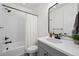 Bright bathroom with a shower, white tile surround, and modern vanity at 751 Green Mountain Dr, Erie, CO 80516