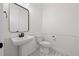 Elegant powder room featuring pedestal sink, modern black fixtures, and decorative tile flooring at 751 Green Mountain Dr, Erie, CO 80516