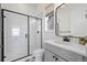 Modern bathroom with glass enclosed shower, subway tile, gray vanity and black fixtures at 751 Green Mountain Dr, Erie, CO 80516