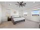 Bright, carpeted bedroom with modern tray ceiling, large windows and mountain views at 751 Green Mountain Dr, Erie, CO 80516