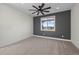 Neutral carpeted bedroom with a modern accent wall and window with scenic views at 751 Green Mountain Dr, Erie, CO 80516