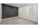 Neutral bedroom with a dark accent wall, carpeted floors, and a window at 751 Green Mountain Dr, Erie, CO 80516