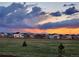 View of the community at sunset with cloudy skies over the mountain range at 751 Green Mountain Dr, Erie, CO 80516