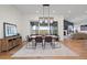 Bright dining room with hardwood floors, stylish light fixture, and sliding glass doors to the outdoor space at 751 Green Mountain Dr, Erie, CO 80516