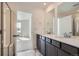 Bathroom featuring double sinks, and tile flooring that leads into an adjacent room at 16572 E 109Th Ave, Commerce City, CO 80022