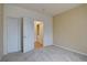 Bedroom featuring carpet flooring and access to a laundry room at 9691 W Coco Cir # 202, Littleton, CO 80128